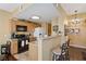 Functional kitchen includes oak cabinets, modern appliances, a breakfast bar and neutral countertops at 7701 W Robindale Rd # 274, Las Vegas, NV 89113