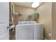 Bright laundry room with a washer, dryer, and overhead shelving at 7701 W Robindale Rd # 274, Las Vegas, NV 89113
