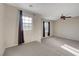 Spacious bedroom showcasing carpet, dual windows and ceiling fan, offering comfort and plenty of natural light at 7856 Carysford Ave, Las Vegas, NV 89178