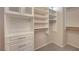 Walk-in closet featuring custom white shelving, drawers and plenty of space at 7856 Carysford Ave, Las Vegas, NV 89178