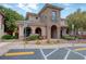 Beautiful clubhouse featuring stone accents, arched entrances, and manicured landscaping at 7856 Carysford Ave, Las Vegas, NV 89178