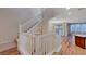 Grand entryway showcasing staircase with white railing and hardwood floors, leading to the living area with lots of natural light at 7856 Carysford Ave, Las Vegas, NV 89178