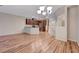 Open kitchen with granite countertops, stainless steel appliances, and wood floors at 7856 Carysford Ave, Las Vegas, NV 89178