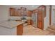 Modern kitchen with stainless appliances, granite counters, and warm wood floors at 7856 Carysford Ave, Las Vegas, NV 89178