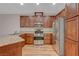 Modern kitchen with stainless appliances, granite counters, and warm wood floors at 7856 Carysford Ave, Las Vegas, NV 89178