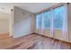 A bright living room is lit by large windows with sheer curtains, complemented by wood floors, for a serene space at 7856 Carysford Ave, Las Vegas, NV 89178