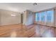 A spacious living room with wood floors, large windows, and slider to balcony are ideal for relaxation and entertaining at 7856 Carysford Ave, Las Vegas, NV 89178