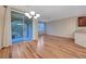 Bright living room with glass sliding door to patio, sleek wood floors, and modern lighting at 7856 Carysford Ave, Las Vegas, NV 89178