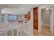 Open floor plan living space with hardwood floors, white railing, and windows at 7856 Carysford Ave, Las Vegas, NV 89178