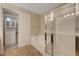 Elegant bathroom featuring a soaking tub, glass enclosed shower, and private access to a walk-in closet at 7856 Carysford Ave, Las Vegas, NV 89178