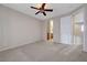 Main bedroom featuring neutral carpet, ceiling fan, ensuite access, and a private entrance at 7856 Carysford Ave, Las Vegas, NV 89178