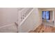 Carpeted staircase with white railing leads to upper level with hardwood flooring at 7856 Carysford Ave, Las Vegas, NV 89178