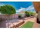 Charming backyard with brick patio, lush landscaping, and mountain views at 819 Sandsprings St, Henderson, NV 89011