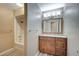 A bathroom vanity with wood cabinets, granite countertops, and shower-tub combination at 819 Sandsprings St, Henderson, NV 89011