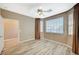 Bright bedroom featuring wood-look flooring, large window, and ceiling fan at 819 Sandsprings St, Henderson, NV 89011