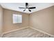 A bedroom features neutral paint, wood-look flooring, and bright window at 819 Sandsprings St, Henderson, NV 89011