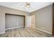 Neutral bedroom featuring wood-look flooring, large window, and an open closet at 819 Sandsprings St, Henderson, NV 89011