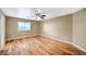 Cozy bedroom with hardwood floors, a ceiling fan, and a window for natural light at 819 Sandsprings St, Henderson, NV 89011