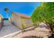 Home's exterior featuring a lush tree and paved walkway at 819 Sandsprings St, Henderson, NV 89011