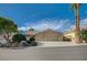 Charming single-story home with a two-car garage, beautiful landscaping, and blue sky in a quiet neighborhood at 819 Sandsprings St, Henderson, NV 89011