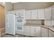 A kitchen area showcases pristine white cabinetry, modern appliances, and ample counter space at 819 Sandsprings St, Henderson, NV 89011
