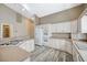 Well-equipped kitchen with modern appliances, ample counter space, white cabinets, and stylish wood-look flooring at 819 Sandsprings St, Henderson, NV 89011