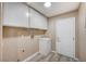 A laundry room with white cabinets and a utility sink at 819 Sandsprings St, Henderson, NV 89011