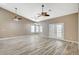 Spacious living area with double doors and large windows, ceiling fans, providing lots of natural light at 819 Sandsprings St, Henderson, NV 89011