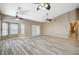 Expansive living area featuring natural light from large windows, and wooden-style floors, and ceiling fans at 819 Sandsprings St, Henderson, NV 89011