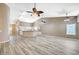 Open-concept living room connected to the kitchen, featuring high ceilings, ceiling fans, and stylish flooring at 819 Sandsprings St, Henderson, NV 89011