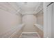 A walk-in closet offers ample storage with built-in shelving and wood-look flooring at 819 Sandsprings St, Henderson, NV 89011
