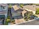 Aerial view of a modern home featuring desert landscaping, a paver driveway, and an attached two-car garage at 8346 Vinamala Ave, Las Vegas, NV 89149