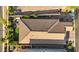 Aerial shot showcasing a tiled roof, a manicured lawn, patio furniture, and the home's layout at 8346 Vinamala Ave, Las Vegas, NV 89149