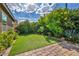 Serene backyard featuring green grass and colorful flowers at 8346 Vinamala Ave, Las Vegas, NV 89149