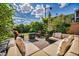 Relaxing backyard featuring a seating area, an umbrella, and lush landscaping at 8346 Vinamala Ave, Las Vegas, NV 89149