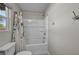 Bathroom with a white tub and shower, decorative shower curtain, toilet, and chrome towel hooks at 8346 Vinamala Ave, Las Vegas, NV 89149