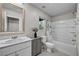 Bright bathroom featuring a tub with shower, a vanity with sink and grey cabinets, and natural light at 8346 Vinamala Ave, Las Vegas, NV 89149