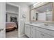 Bathroom with double sinks, modern fixtures, and view of bedroom at 8346 Vinamala Ave, Las Vegas, NV 89149