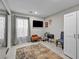 Bedroom with large window, curtains, neutral paint, a TV, furnishings, and a patterned area rug at 8346 Vinamala Ave, Las Vegas, NV 89149