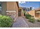 Inviting entrance with a stone-accented facade, paved walkway, and lush landscaping at 8346 Vinamala Ave, Las Vegas, NV 89149
