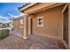 Inviting front porch with tiled flooring, supported pillars, and a warm welcome mat at 8346 Vinamala Ave, Las Vegas, NV 89149