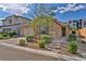 Charming single-story home featuring a paved driveway, desert landscaping, and a two-car garage at 8346 Vinamala Ave, Las Vegas, NV 89149