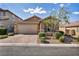 Charming single-story home with a two-car garage, paved driveway, and mature desert landscaping at 8346 Vinamala Ave, Las Vegas, NV 89149