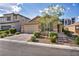 Charming single-story home featuring a paved driveway, desert landscaping, and a two-car garage at 8346 Vinamala Ave, Las Vegas, NV 89149