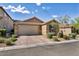 Charming single-story home with a two-car garage, paved driveway, and desert landscaping at 8346 Vinamala Ave, Las Vegas, NV 89149