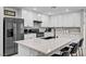 Beautiful kitchen boasts white cabinets, stainless steel appliances, and a spacious island with bar seating at 8346 Vinamala Ave, Las Vegas, NV 89149