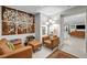 Living room with neutral paint, modern light fixture, artwork, and leather seating arrangement at 8346 Vinamala Ave, Las Vegas, NV 89149