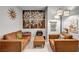 Living room with neutral paint, modern light fixture, artwork, and leather seating arrangement at 8346 Vinamala Ave, Las Vegas, NV 89149