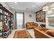 Living room with neutral paint, decorative lighting, shelving, artwork, a window, and a brown area rug at 8346 Vinamala Ave, Las Vegas, NV 89149