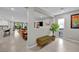 Open-concept living area with a half wall, a sliding glass door, and wood-look flooring throughout at 8346 Vinamala Ave, Las Vegas, NV 89149